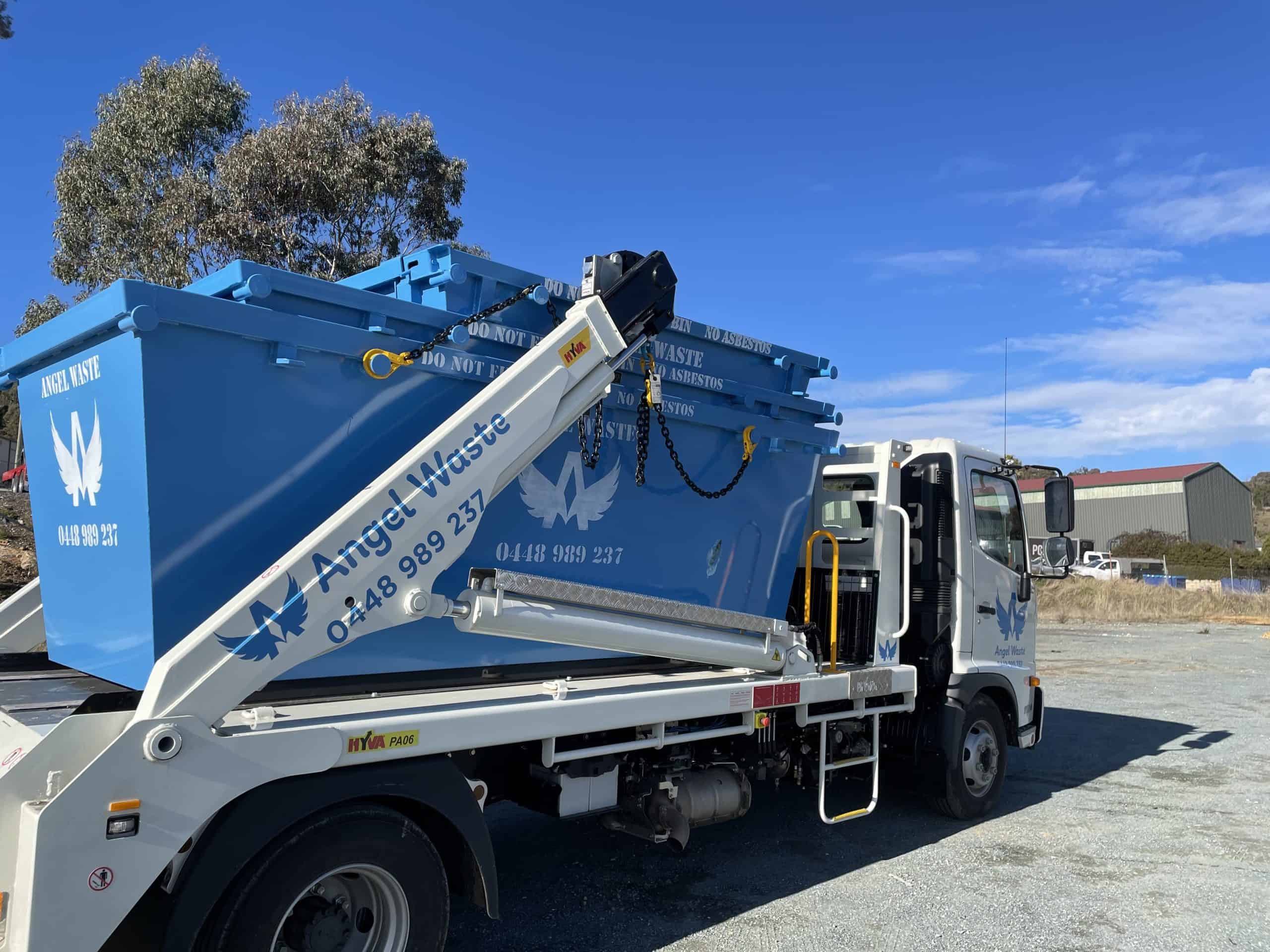 From the rear of a skip bin truck, focusing on the skip bins the truck is carrying.